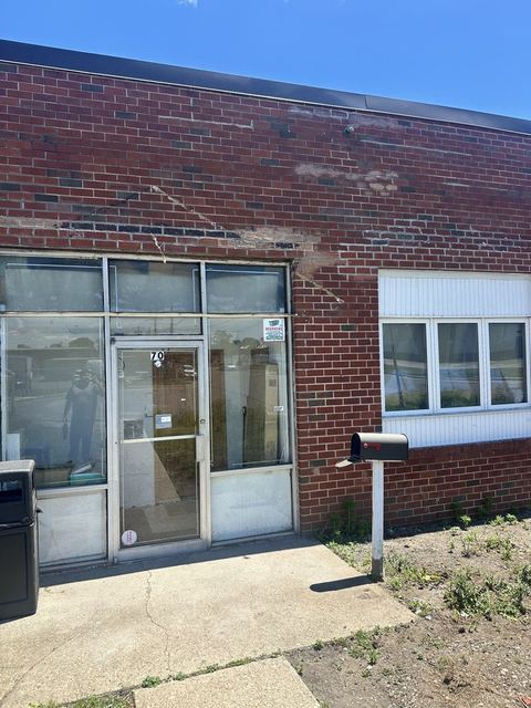 Front elevation after completion with awning removed and new lintels set above the entry and office windows