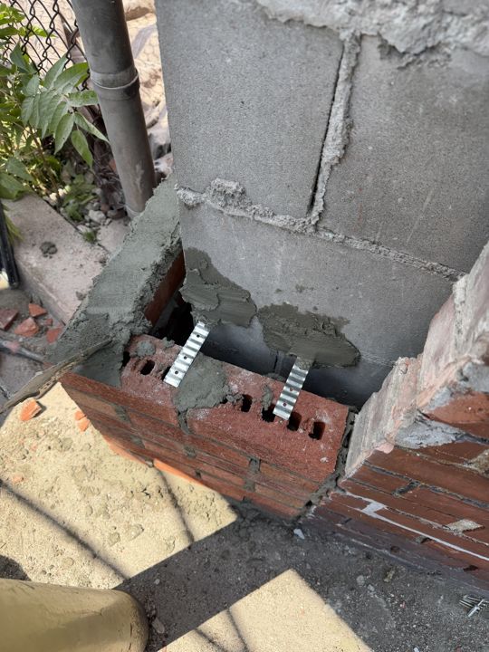 Brick removed down to sound masonry at the corner.
