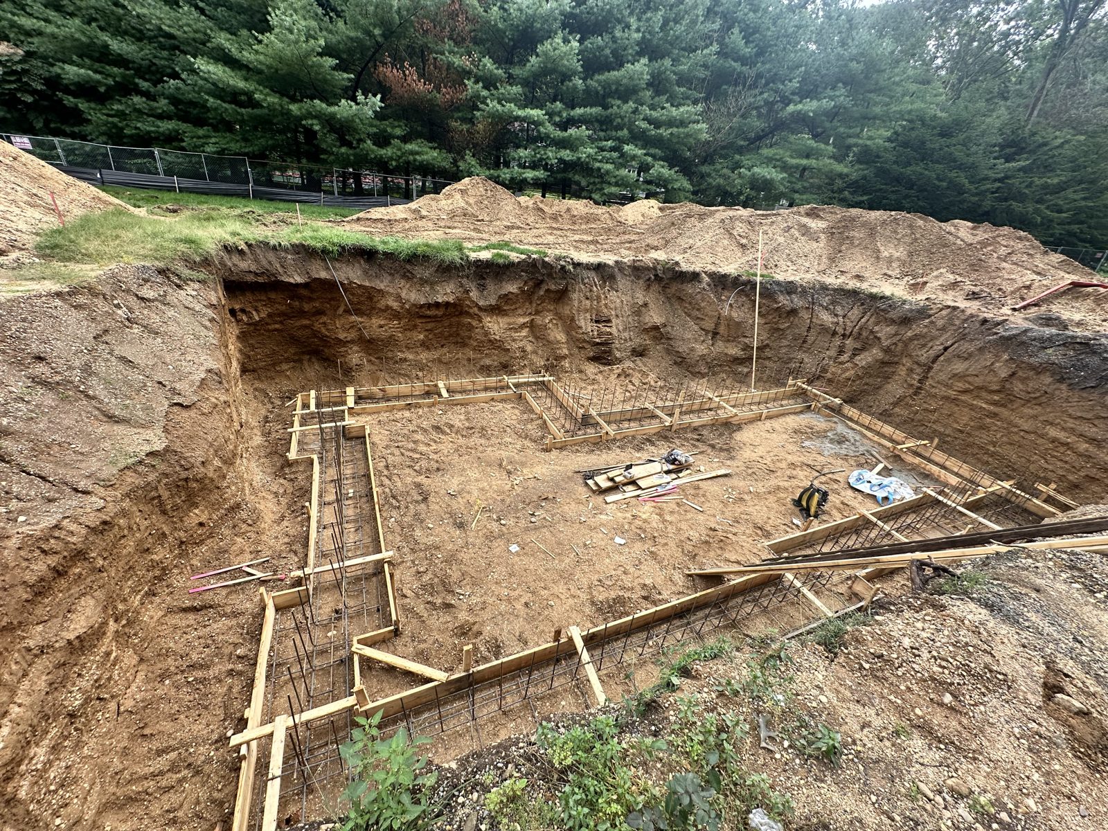 Footing forms laid out in the excavation for a custom home in Muttontown