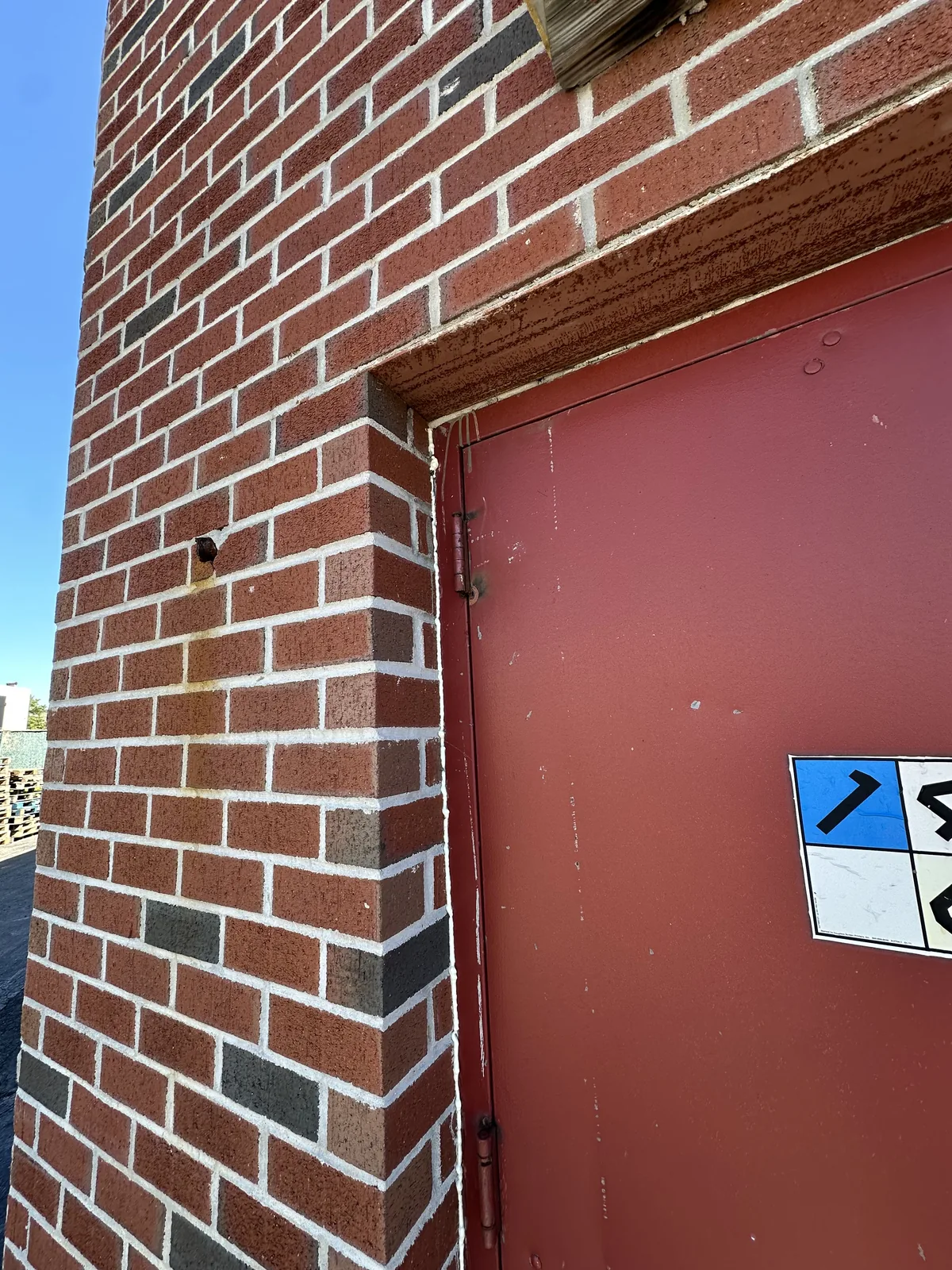 Commercial exterior door and surrounding masonry after repair work