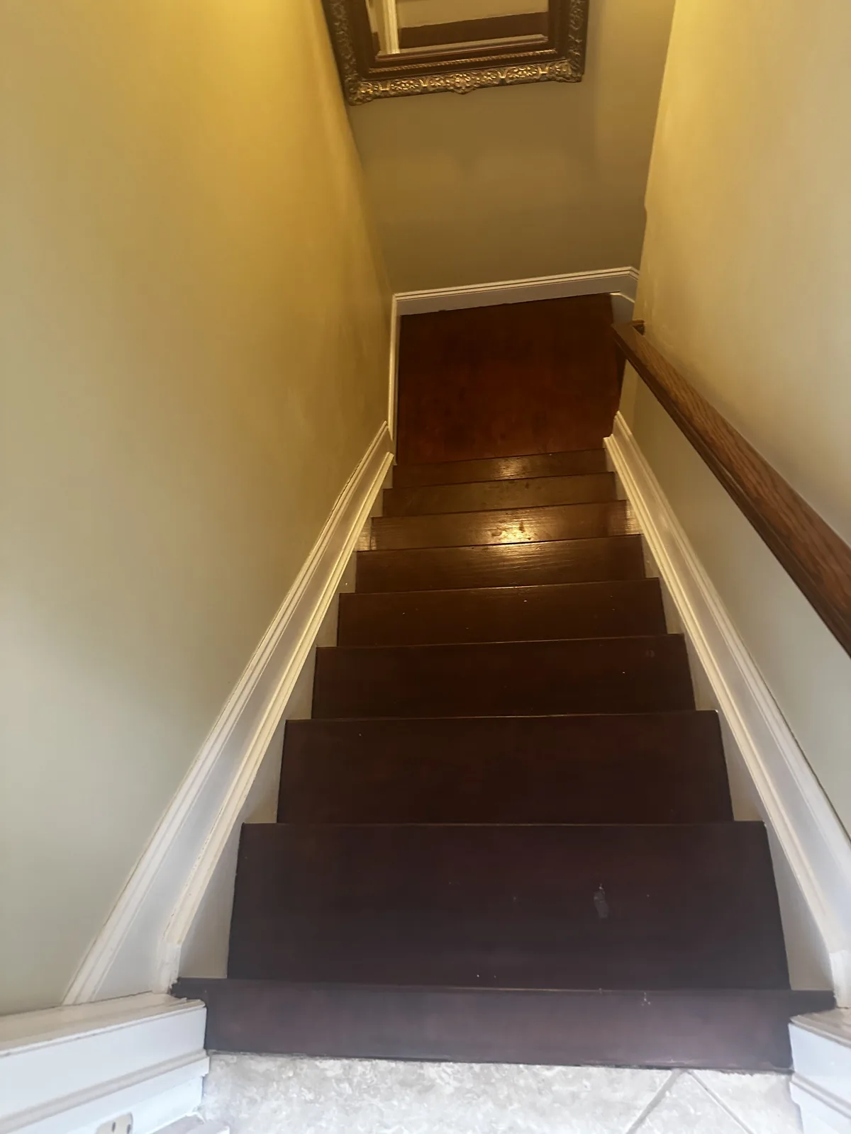 Refinished wood staircase with new treads and painted risers
