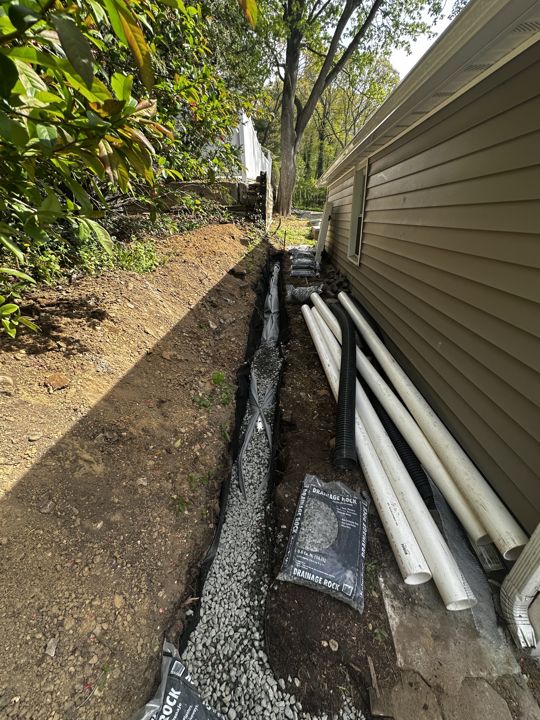 Perforated pipe set along the house foundation.