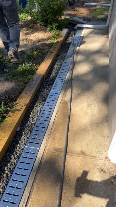 Channel drain cut into the concrete at the driveway.