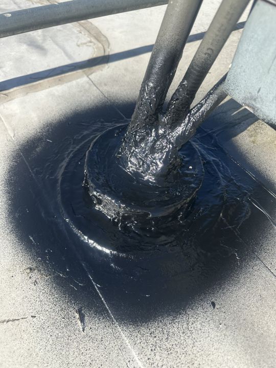 Pipe penetration sealed with a new boot and mastic.